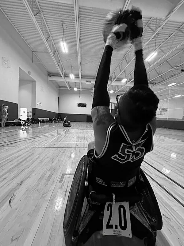 Denver Barbarians athlete reaching overhead for the rugby ball